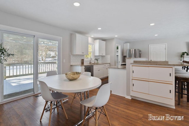 dining area with sink and dark wood-type flooring