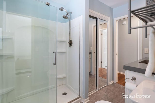 bathroom featuring vanity and a shower with shower door