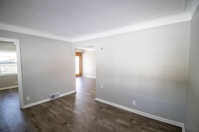 spare room with dark wood-type flooring