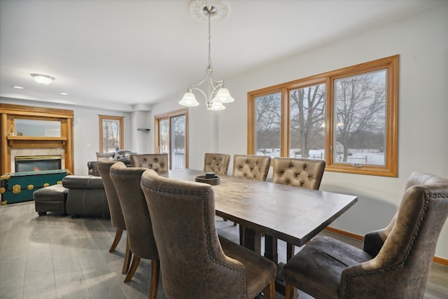 dining room featuring wood-type flooring and an inviting chandelier