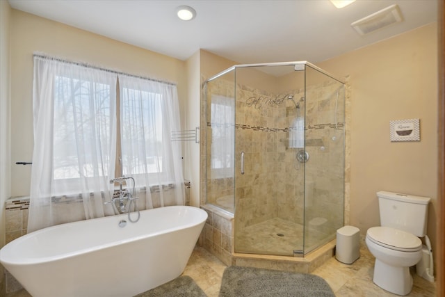 bathroom featuring tile patterned flooring, plus walk in shower, and toilet