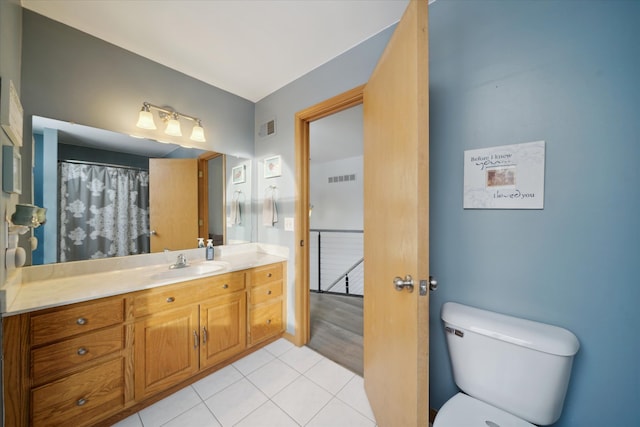 bathroom with vanity, tile patterned floors, and toilet