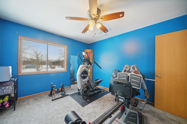 exercise area with ceiling fan and carpet