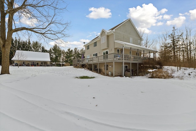 view of snowy exterior with a deck