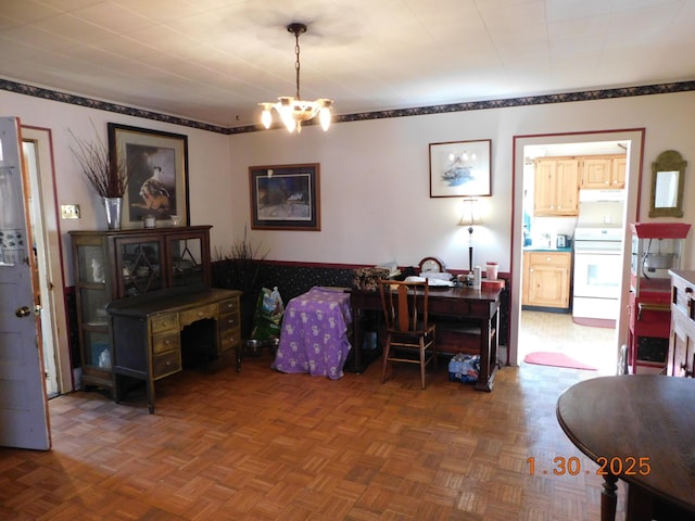 dining space featuring parquet flooring and a chandelier