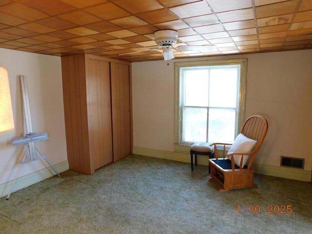 unfurnished room with a paneled ceiling and carpet floors