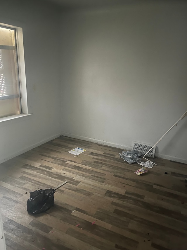 spare room with dark hardwood / wood-style floors