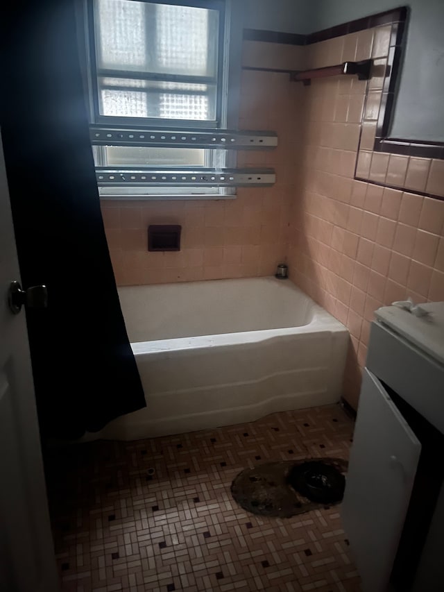 bathroom featuring tile patterned flooring and tile walls