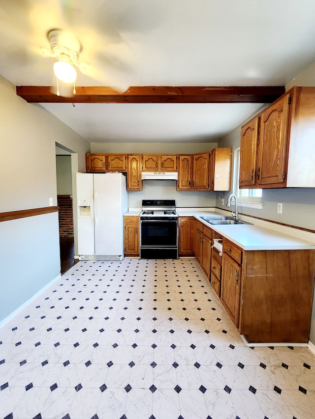 kitchen featuring under cabinet range hood, beam ceiling, white fridge with ice dispenser, gas stove, and a sink