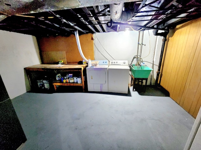 unfinished basement featuring a sink and washer and clothes dryer