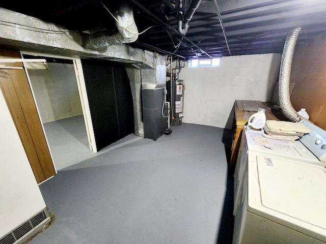 basement with washer / dryer, heating unit, and gas water heater