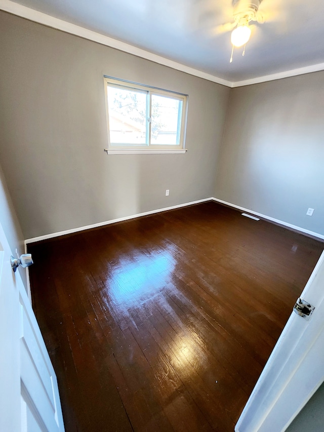 unfurnished room with ceiling fan and dark hardwood / wood-style flooring