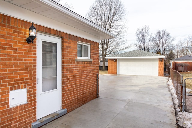 view of side of home featuring a garage and an outbuilding