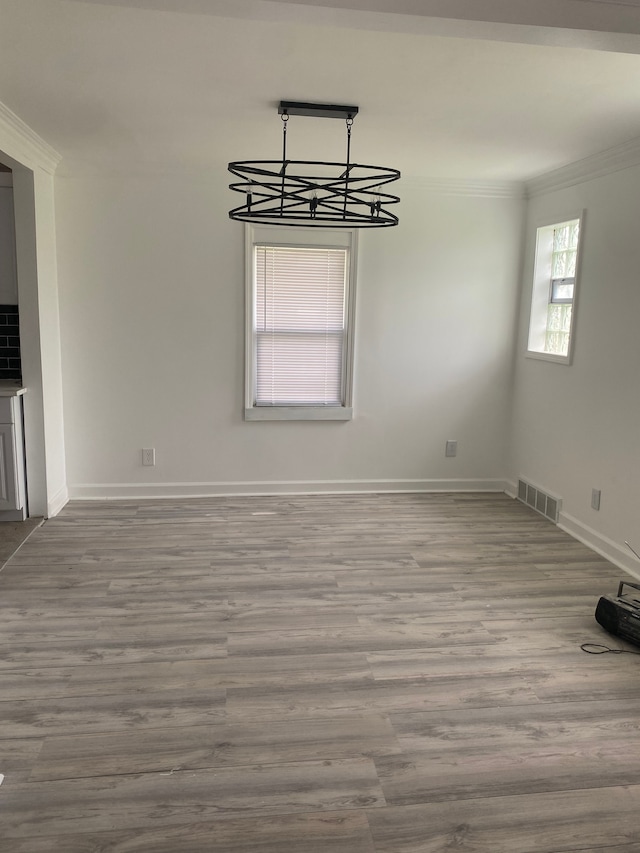 interior space with hardwood / wood-style flooring and ornamental molding