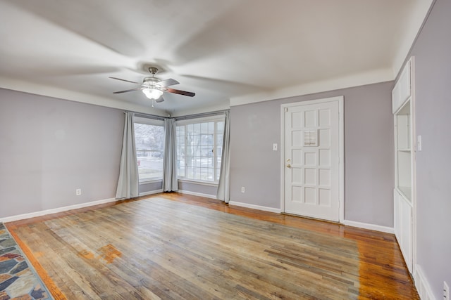 spare room with light hardwood / wood-style floors and ceiling fan