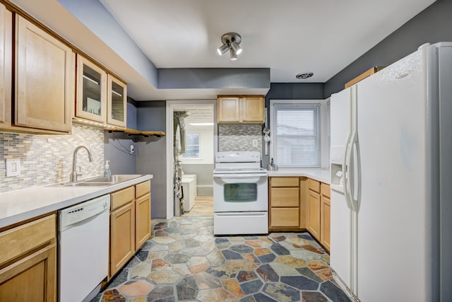 kitchen with sink, light brown cabinets, backsplash, and white appliances