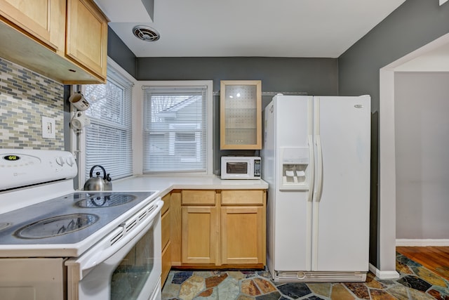 kitchen with tasteful backsplash, light brown cabinets, and white appliances