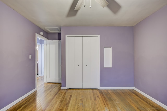 unfurnished bedroom featuring ceiling fan, a closet, and light wood-type flooring