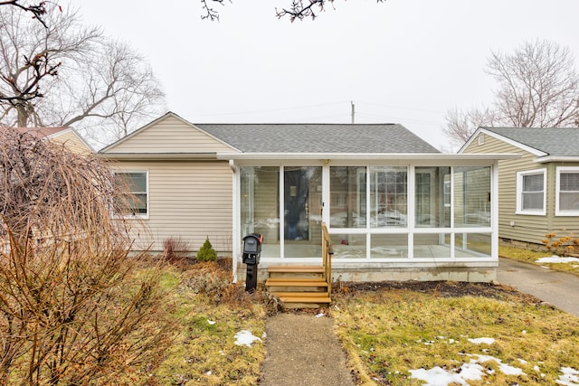 view of front of home with a sunroom