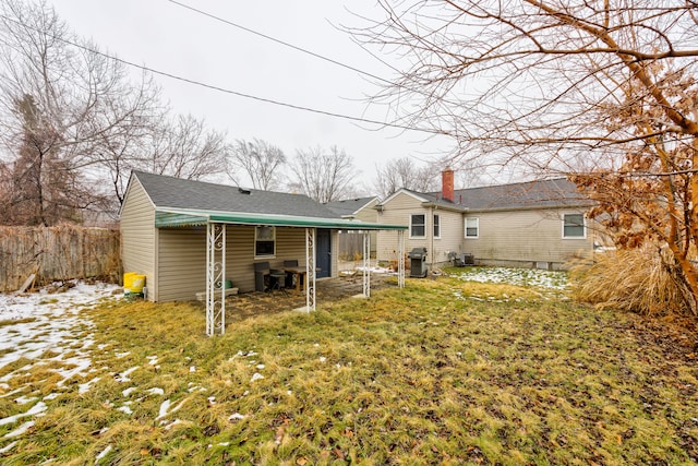 rear view of house with a lawn