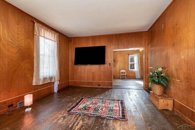 1613 Bay St, Saginaw, MI 48602 - unfurnished living room featuring wood-type flooring and wooden walls