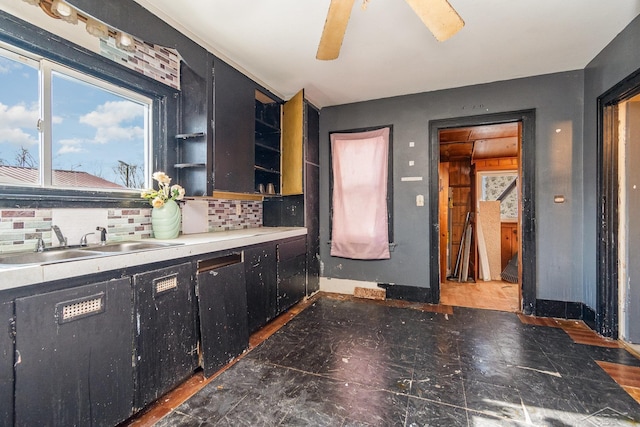 kitchen featuring sink, backsplash, and ceiling fan