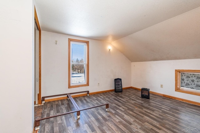 additional living space with vaulted ceiling and dark hardwood / wood-style floors