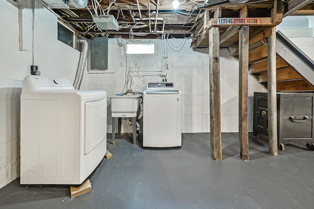 basement featuring sink, electric panel, and independent washer and dryer