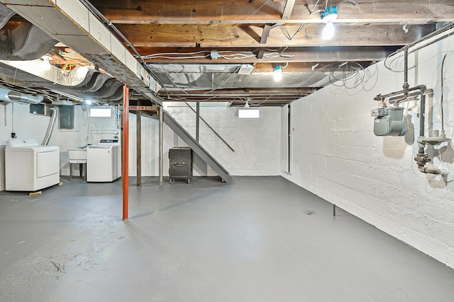 basement with sink, electric panel, and washing machine and dryer