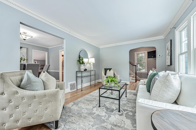 living room with hardwood / wood-style flooring and ornamental molding