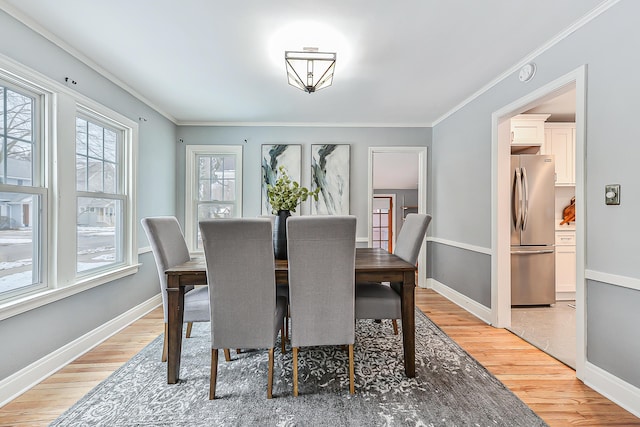 dining room featuring crown molding and hardwood / wood-style floors