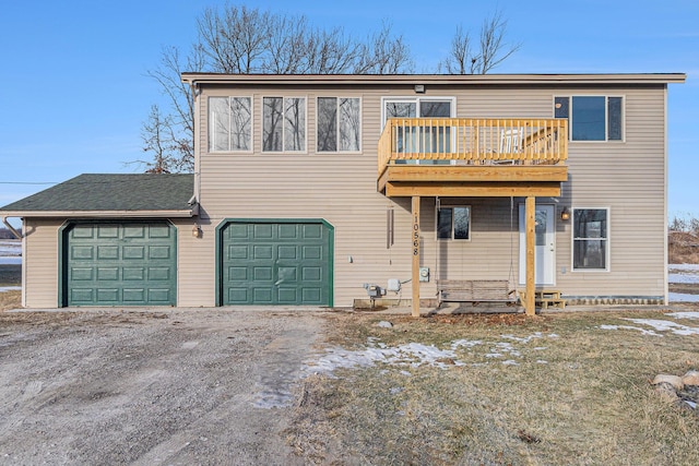 view of front of home featuring a garage and a balcony