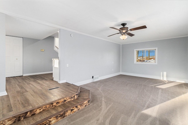 empty room featuring ornamental molding, carpet, and ceiling fan