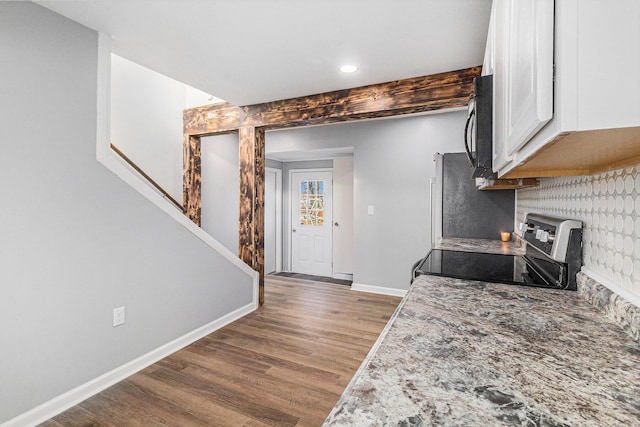 kitchen featuring white cabinetry, dark hardwood / wood-style floors, and stainless steel range with electric cooktop