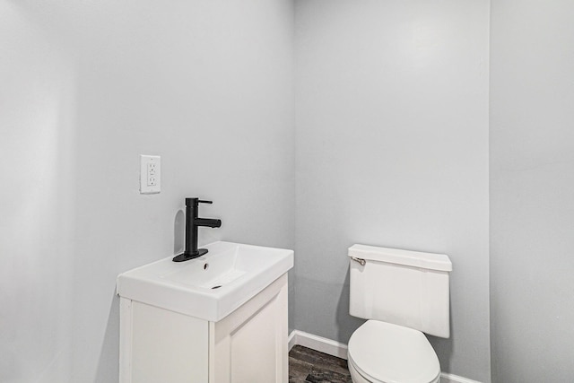 bathroom featuring hardwood / wood-style flooring, vanity, and toilet