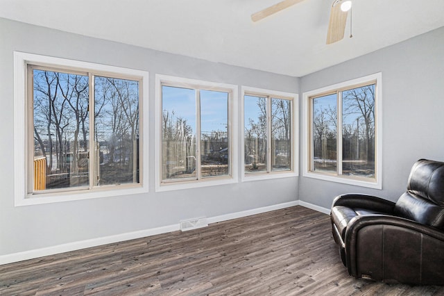 sitting room with dark hardwood / wood-style floors and ceiling fan