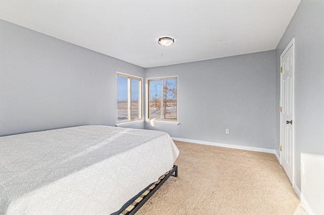 bedroom featuring light colored carpet