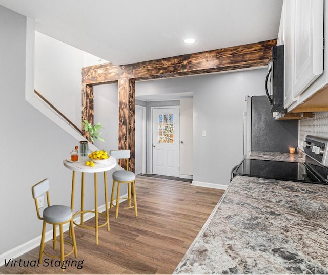 kitchen featuring white cabinetry, stainless steel electric range, and dark hardwood / wood-style flooring