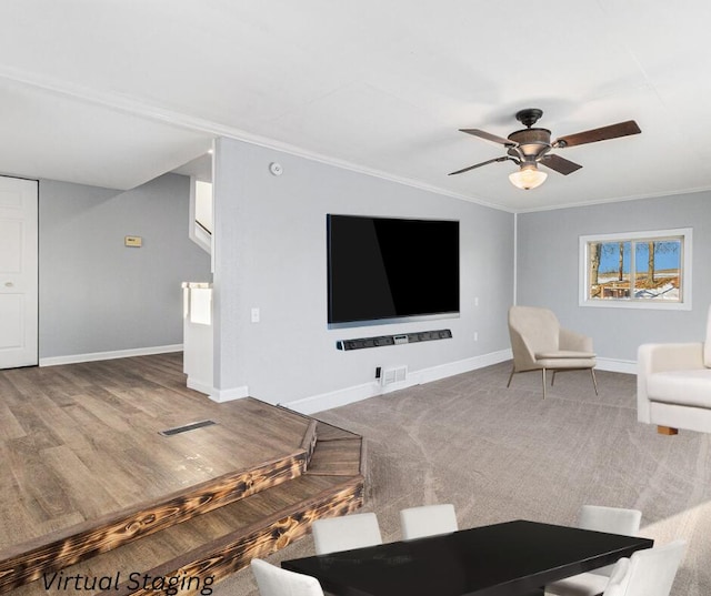 unfurnished living room with ceiling fan and ornamental molding