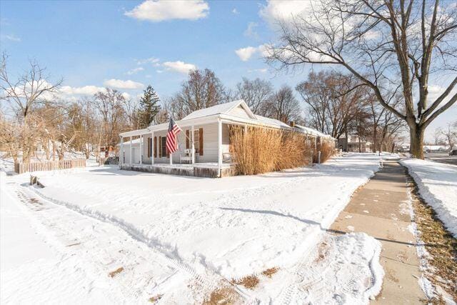 view of snow covered exterior with a porch