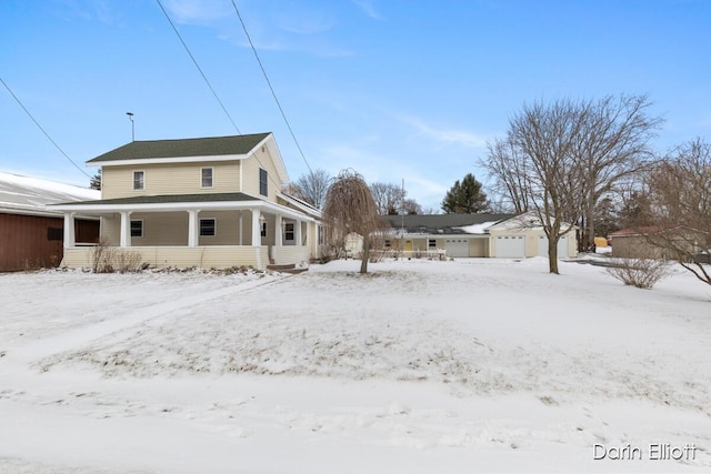 snow covered back of property with a porch