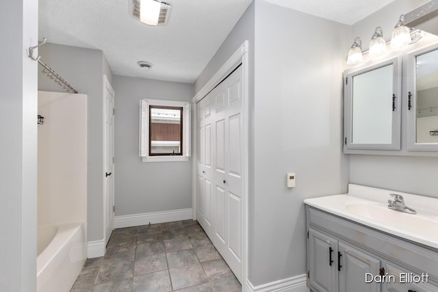 bathroom with vanity and a textured ceiling