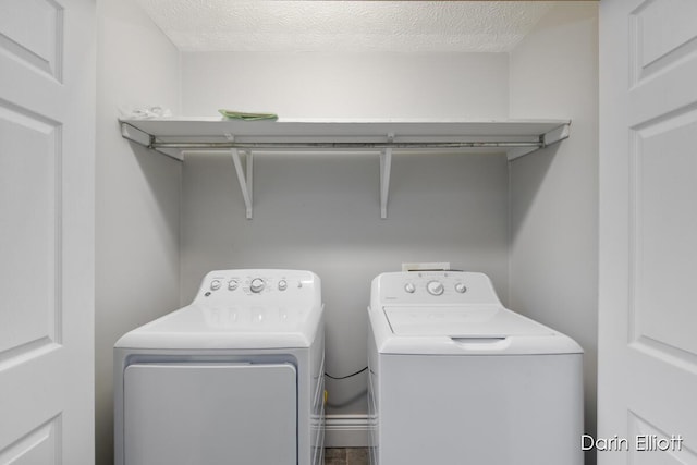 laundry area featuring washer and clothes dryer and a textured ceiling