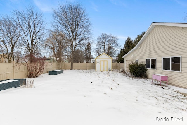 yard layered in snow featuring a shed