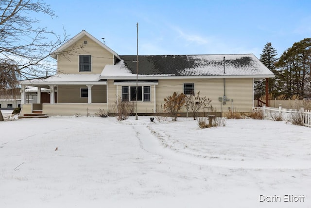 view of snow covered back of property