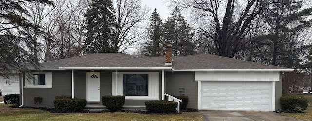 ranch-style home with a garage, concrete driveway, a chimney, roof with shingles, and covered porch