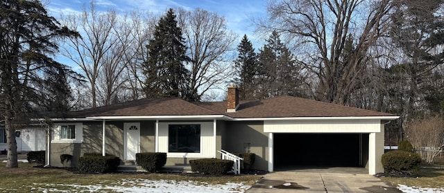 single story home featuring a chimney, concrete driveway, a garage, and a shingled roof