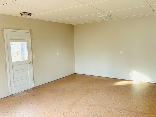 unfurnished room with a drop ceiling