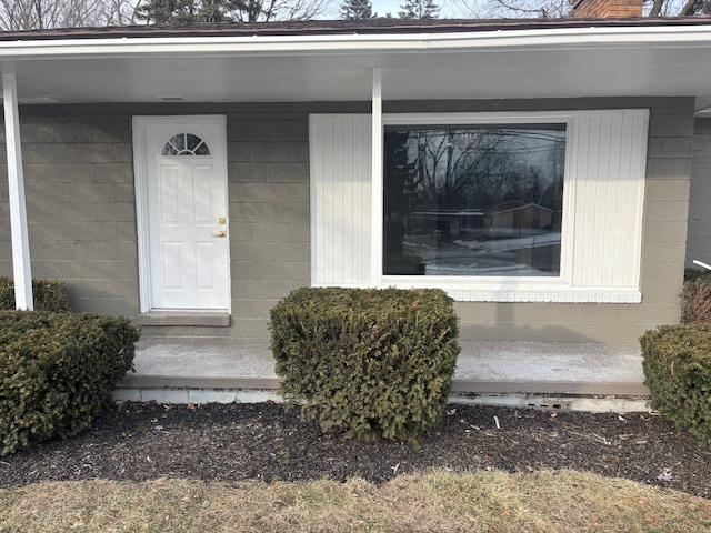 doorway to property featuring concrete block siding