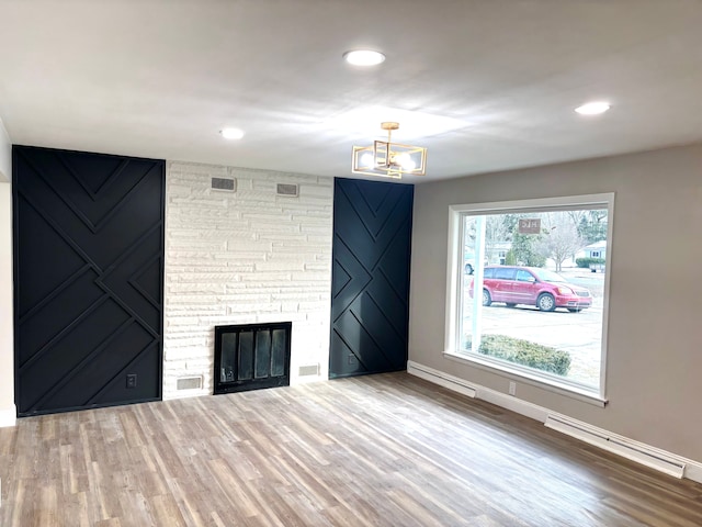 unfurnished living room featuring hardwood / wood-style flooring and a fireplace